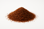 a pile of loose leaf rooibos tea, in a white studio background, very well lit up