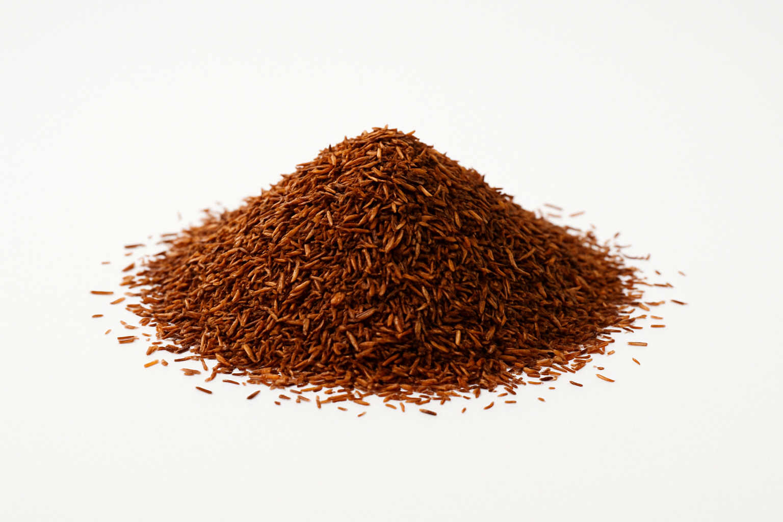 a pile of loose leaf rooibos tea, in a white studio background, very well lit up