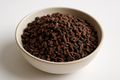 cacao nibs, raw, white background, in a bowl
